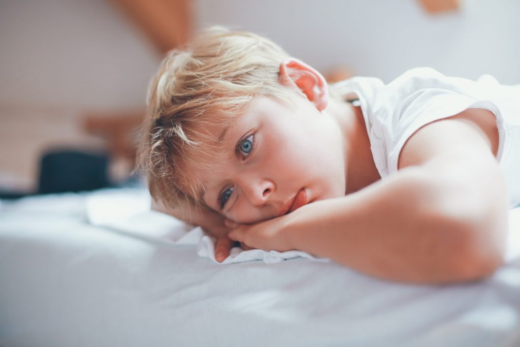 Child laying awake in bed due to sleep apnea